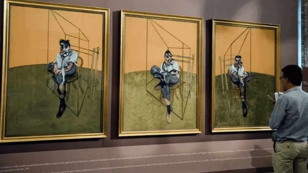 The painting 'Three Studies of Lucian Freud' by Francis Bacon.
This triptych is being viewed by a man in a museum. 
