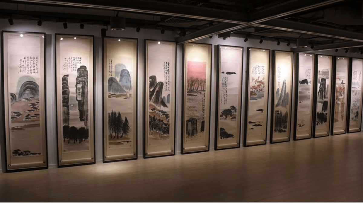 The 16th most expensive painting 'Twelve Landscape Screens' by Qi Baishi is displayed at a museum.