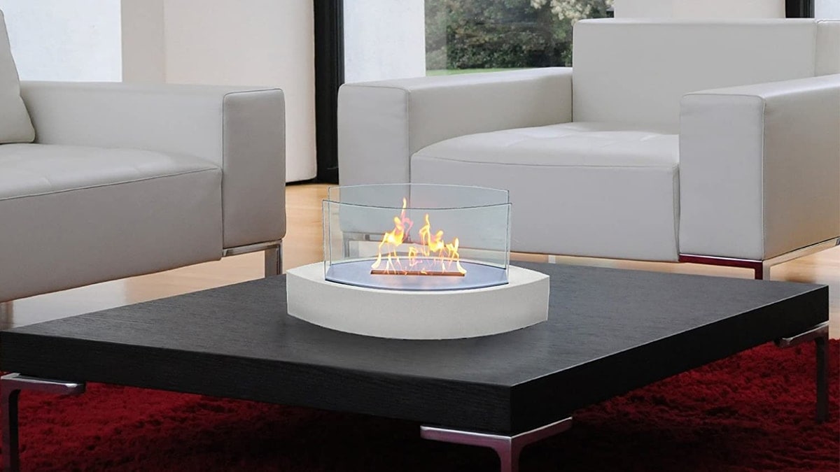 Anywhere fireplace burning on a table in the middle of a beautiful living room. 