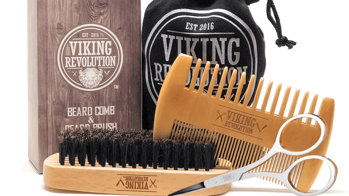 A beard comb and brush set on the white surface. 