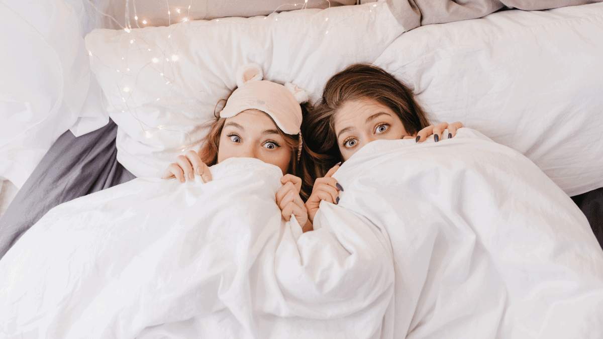Two ladies under the handmade blanket 