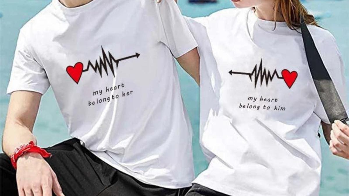 two couples wearing matching t-shirts. On left: man's T-shirt has quote "my heart belong to her". On right, the woman's t-shirt has a quote "my heart belongs to him. 