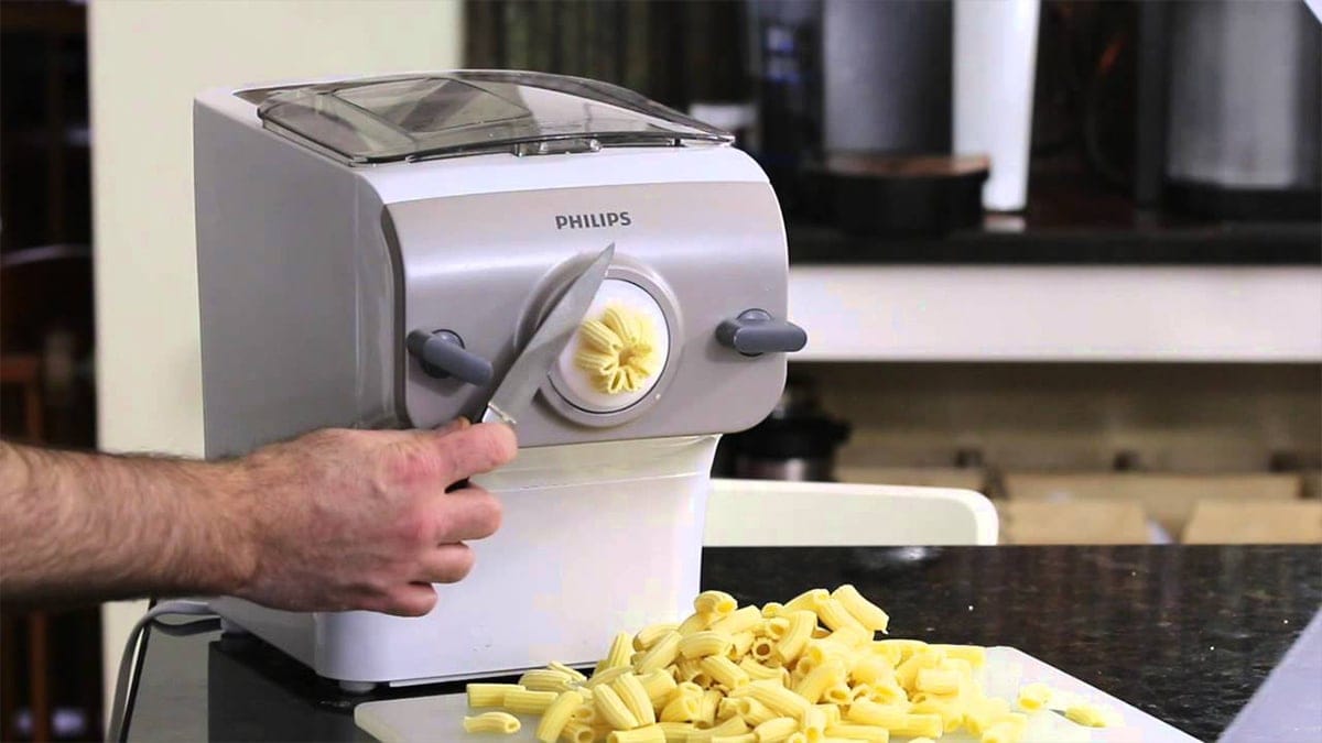 a guy making pasta from a Philips Pasta maker 
