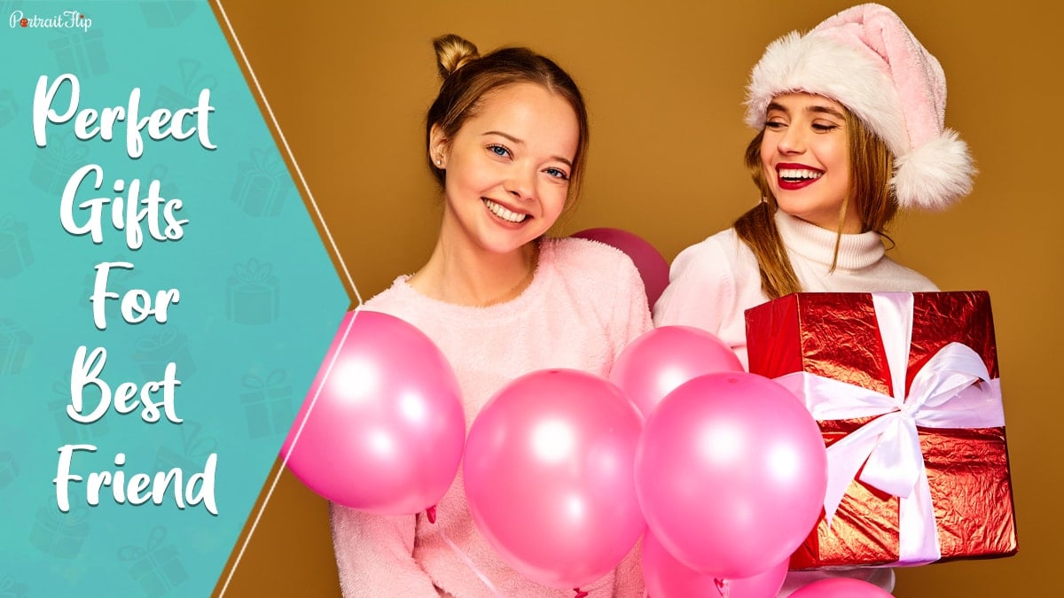 Perfect gifts for best friends: two happy best friends posing with pink balloons and red gift in their hands. 