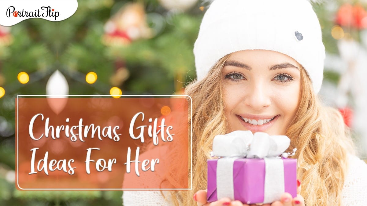 christmas gifts for her: a woman posing with a small gift. 