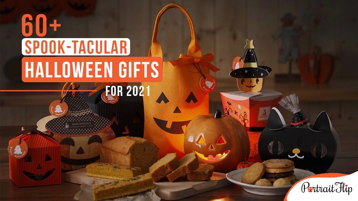 A table full of Halloween candies, treats, and gifts with a pumpkin lamp, with the words 60+ spook-tacular gifts written on the top left corner.