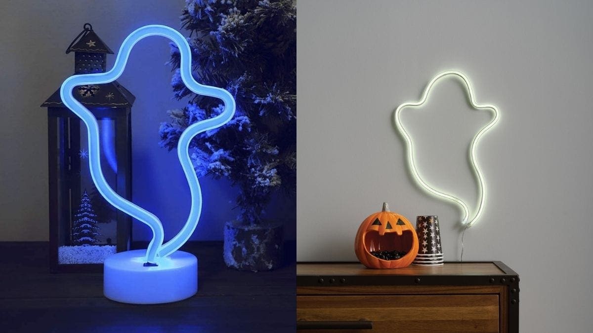 a ghost outlined blue LED lamp kept on a table on the left and on the right a wall decorated with a ghost outlined white LED lamp with halloween day decoration under it.