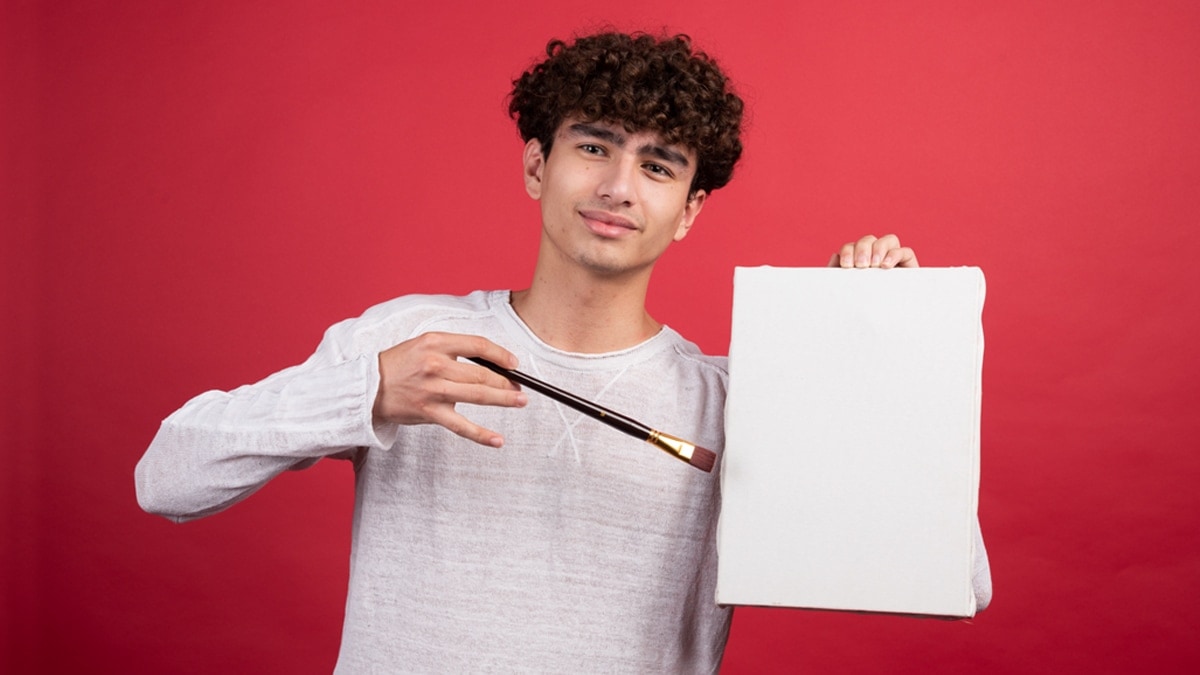 A person holding a small canvas and brush, 