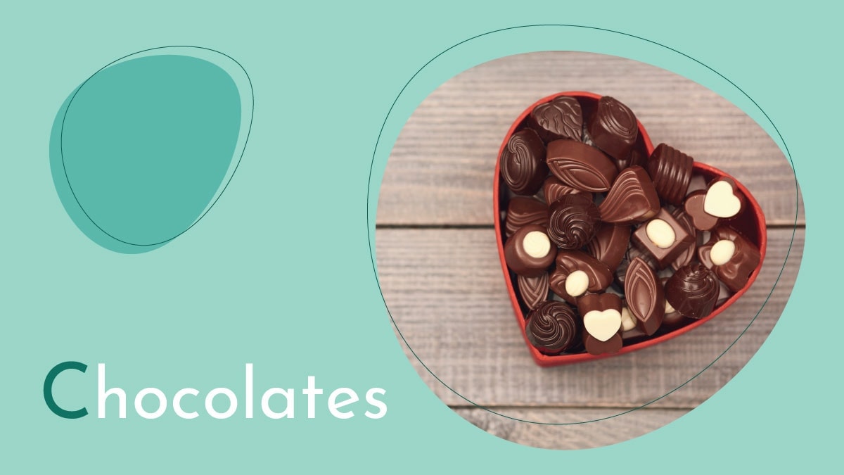 Delicious chocolates on a heart shaped box is placed on the brown surface. 