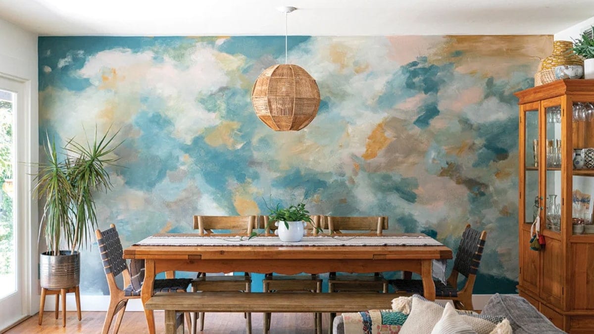 An abstract painting has covered the walls of a dining room. 