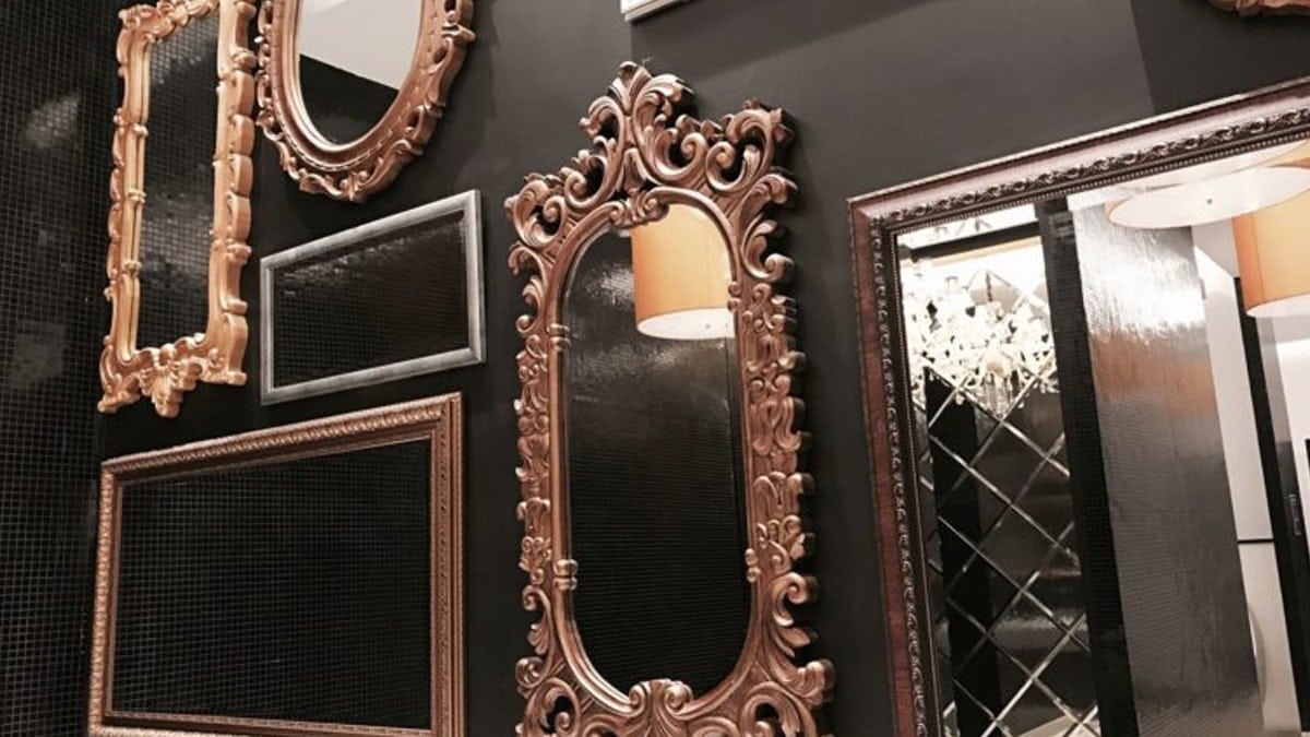 Antique mirrors are installed on the walls of a living room