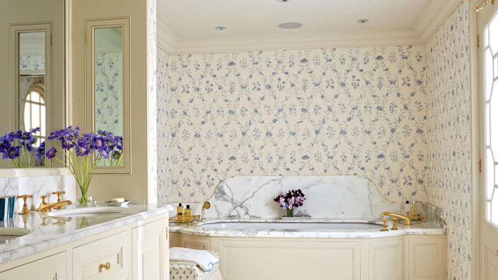 A printed wallpaper is installed on the wall of a bathroom. 