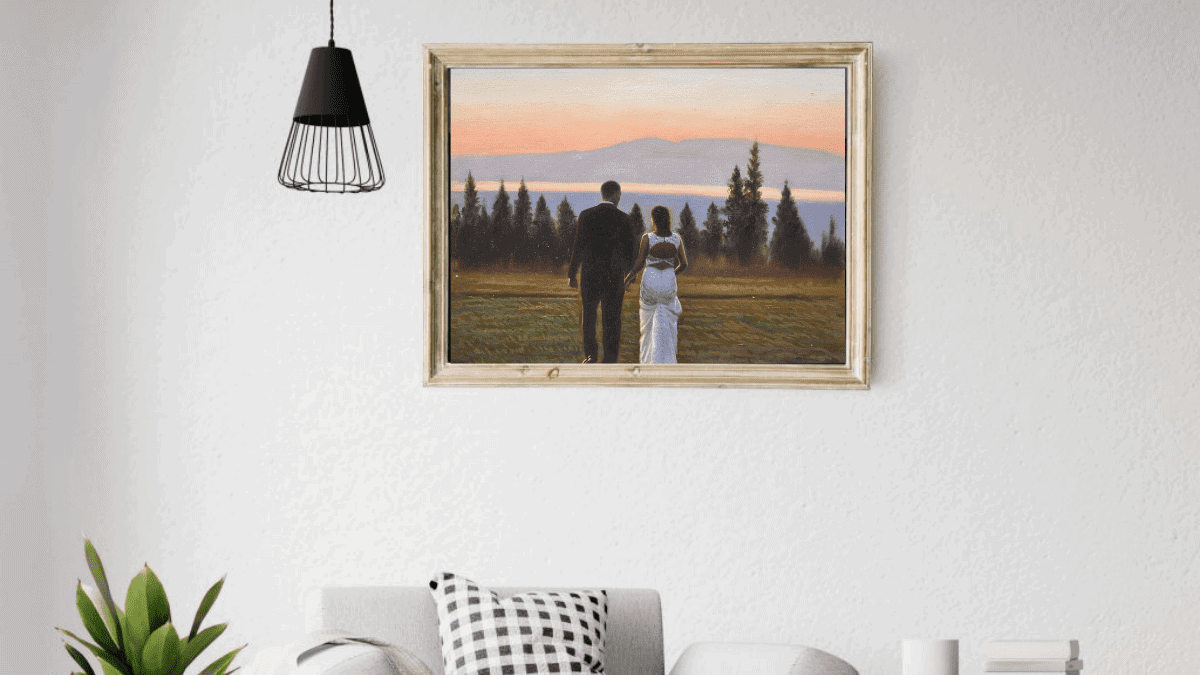 A beautiful interior wall decorated with one of PortraitFlip's customer's wedding portrait of a bride and a groom walking on a field with trees and sunset in the background.