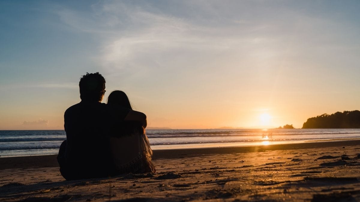 A couple enjoying sunset at the beach.