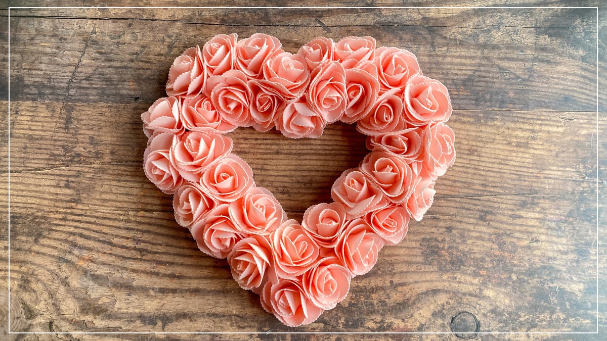 A heart wreath made from peach colored roses. 
