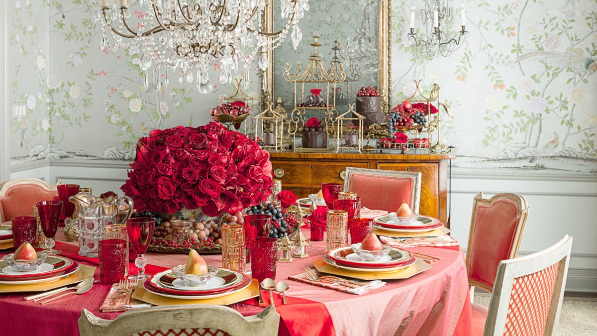 A big rose bouquet is placed on a well decorated dining table. the whole decor follows red, pink, and white color scheme to give an elegant look to home decor. 