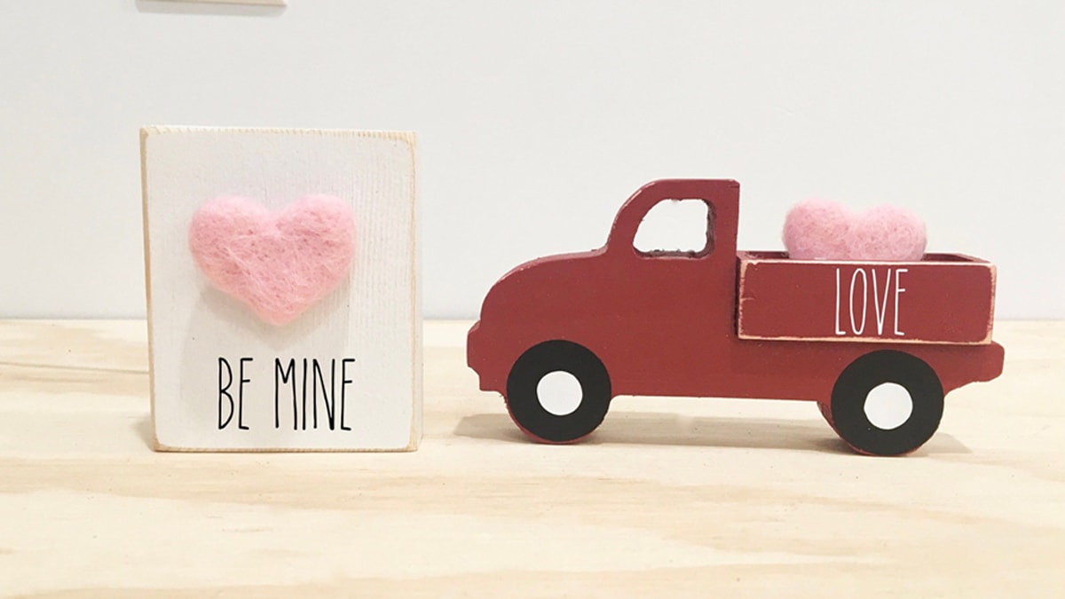Valentine's day truck decor with a "Be Mine" card and a small red truck. 