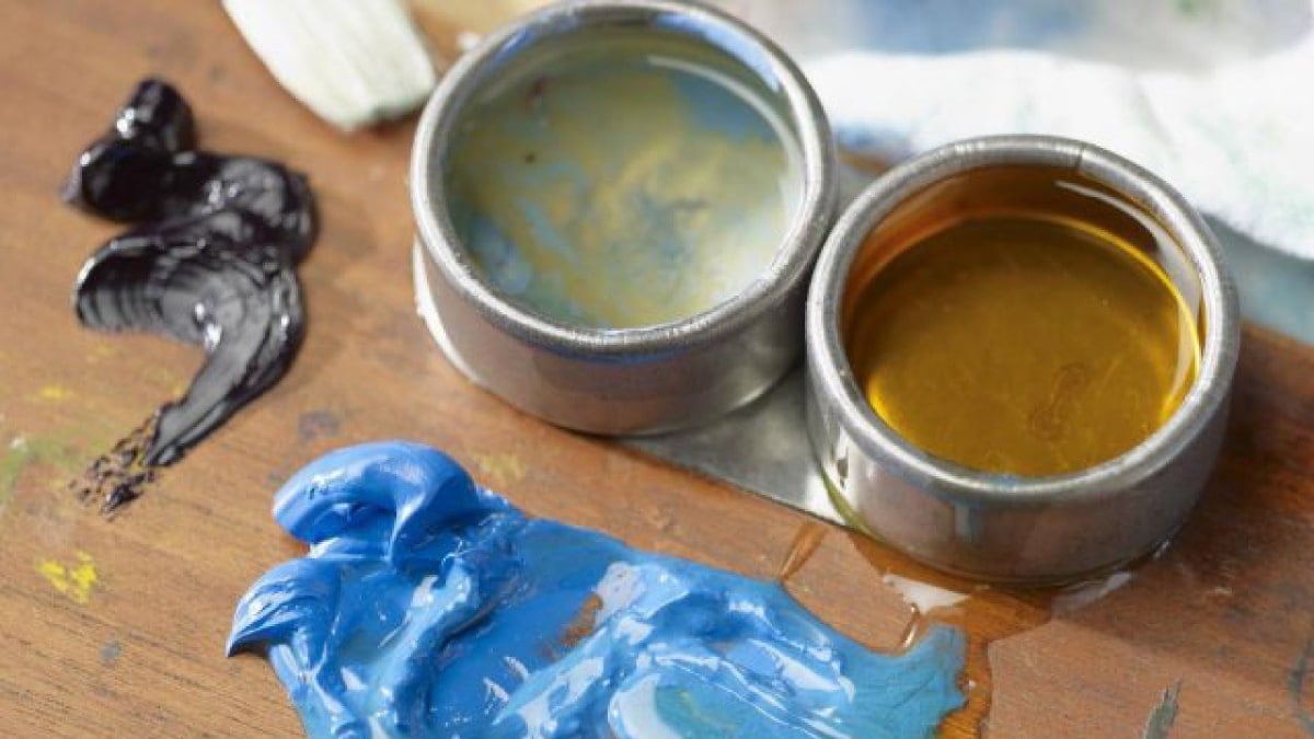 blue paint and black paint on table and turpentine to show how versatile the paint is. 