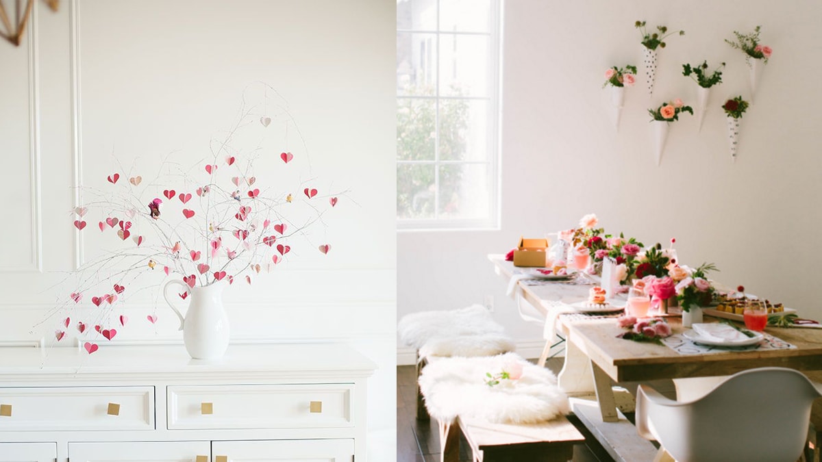 On the left is a vase with a heart decorated branched decor. On the right, a tdining table and wall is decorated with classy valentine's day decor.