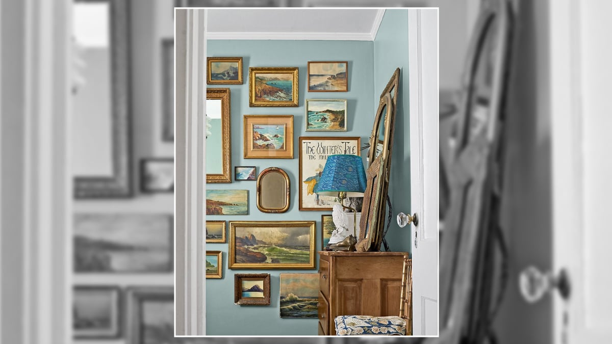 A gallery wall with multiple paintings, photos, and complimenting wall décor pieces.