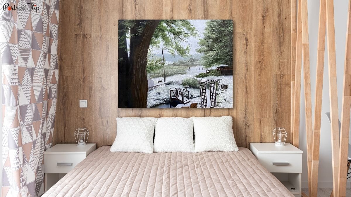 A cozy bedroom interior with a handmade landscape painting from PortraitFlip displayed as a statement piece.