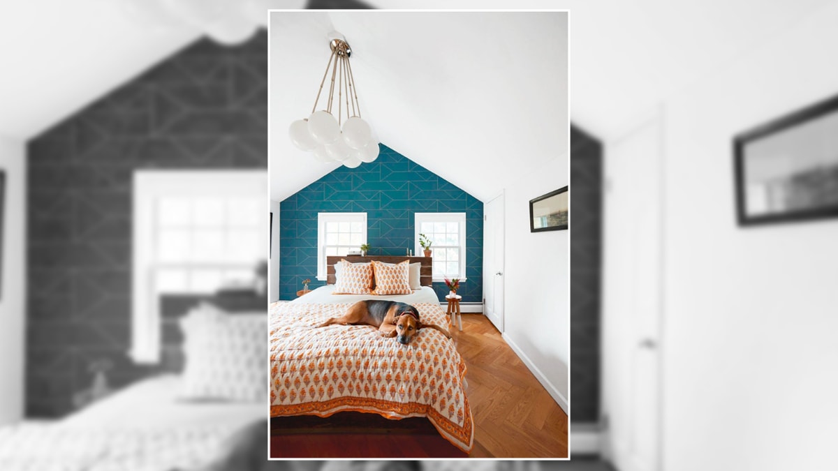 a blue accent wall shown in an all white bedroom.