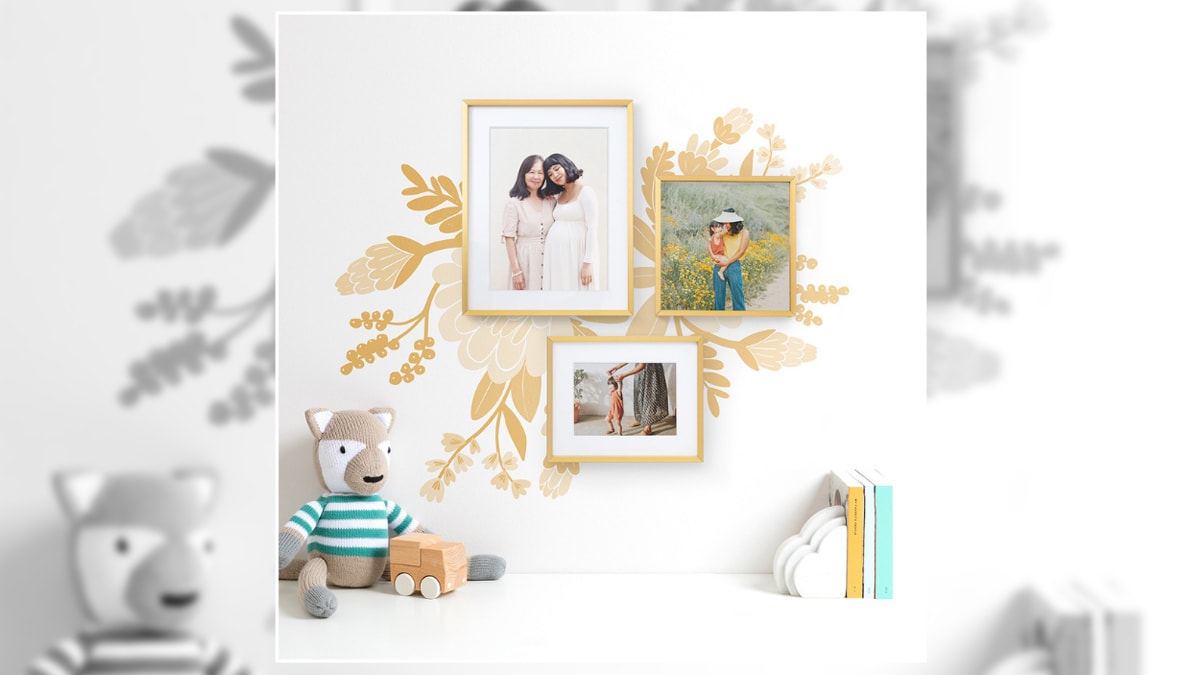 a bedroom wall painted with flowers that has framed artwork displayed on it shown as one of the ideas for bedroom wall décor.