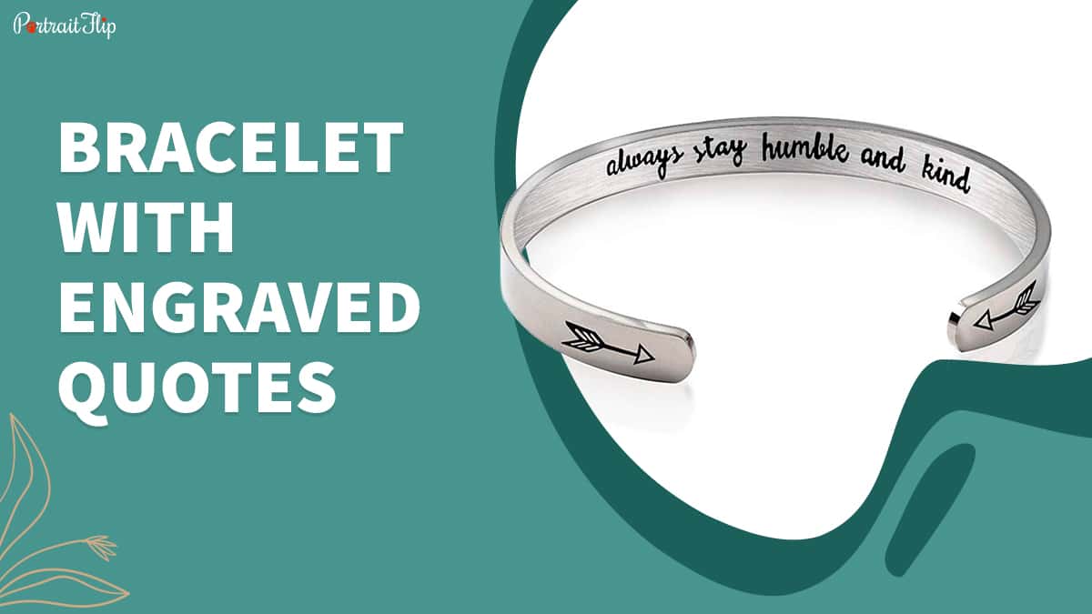 a quote engraved bracelet is placed on the white surface