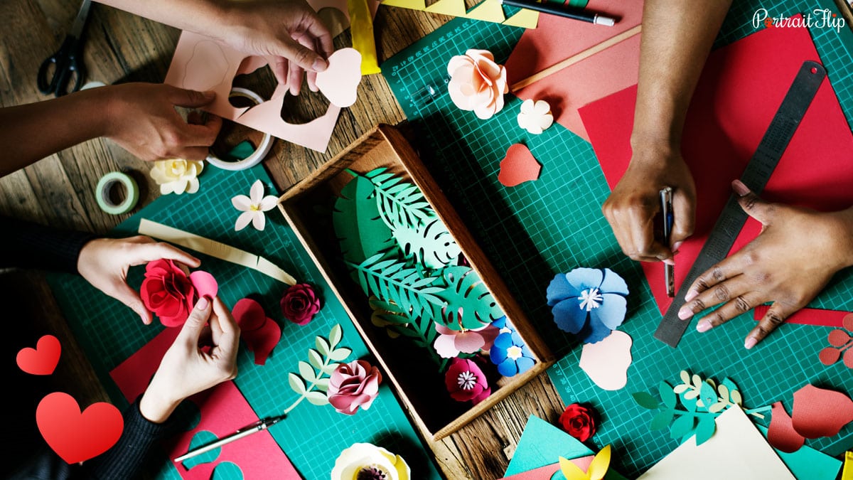 People crafting paper flowers from paper. 