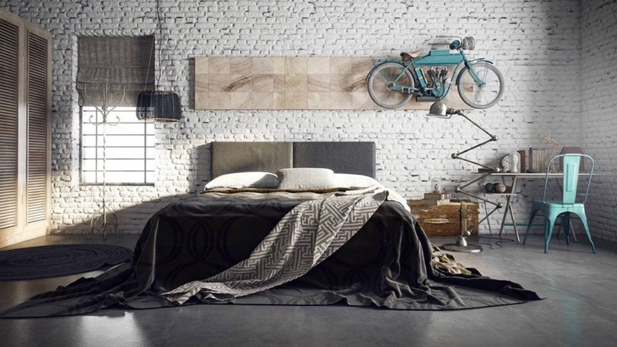 a bedroom wall with exposed bricks is decorated with a bike.