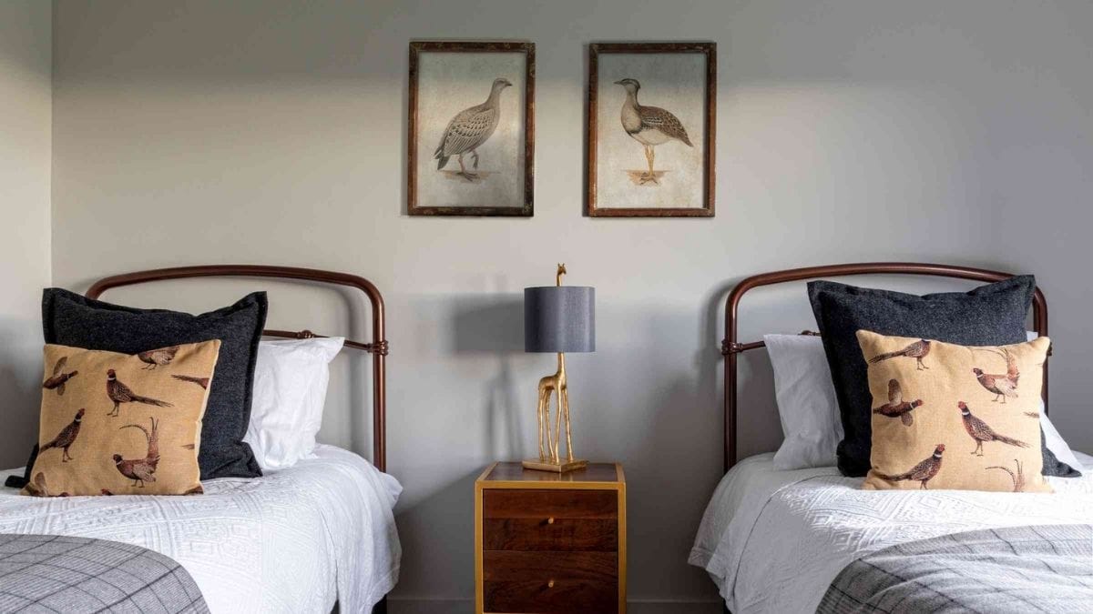 a set of framed fabric frames hanging in a bedroom that also has complimenting pillow covers.