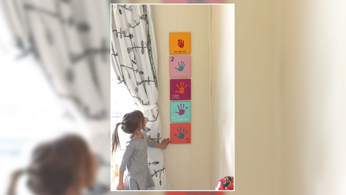 evolving hand prints framed and hung on the wall of a girl's bedroom as a wall decor idea.