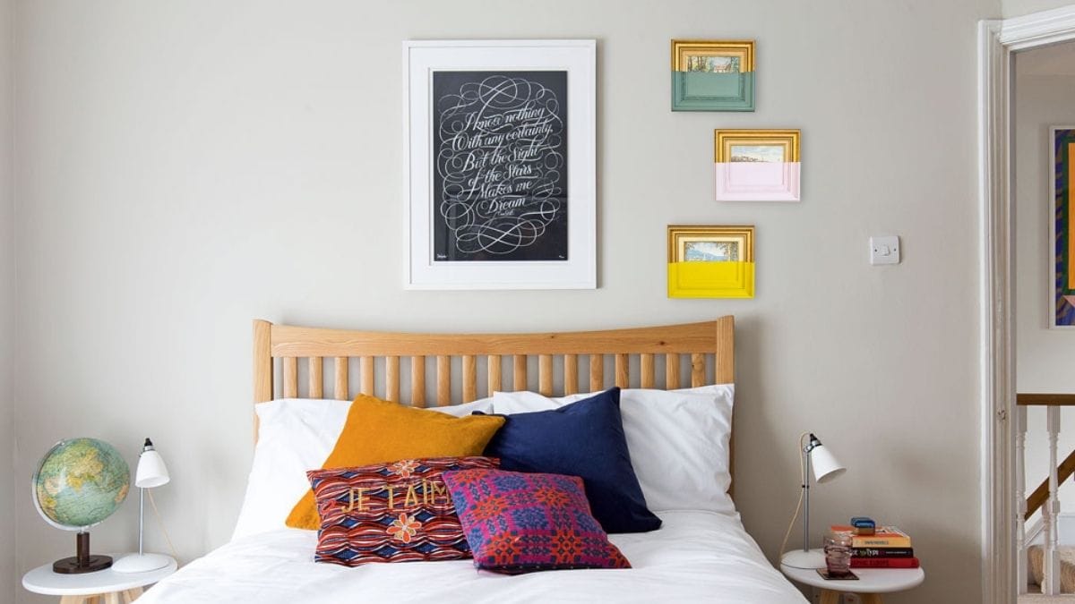 artworks painted with half a paint hanging on a bedroom wall as a décor.