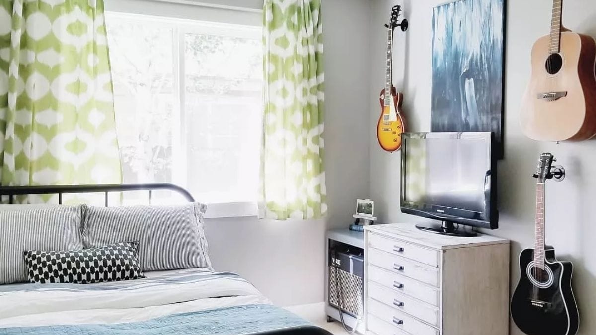 a men's bedroom wall decorated with guitars as a bedroom wall decor idea.