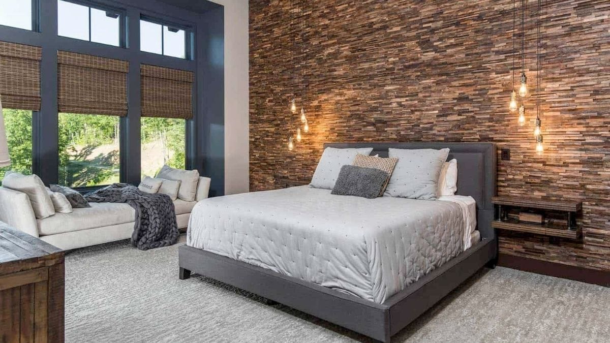 an accent bedroom wall covered from ceiling to the floor in wood shown as a bedroom wall décor idea.