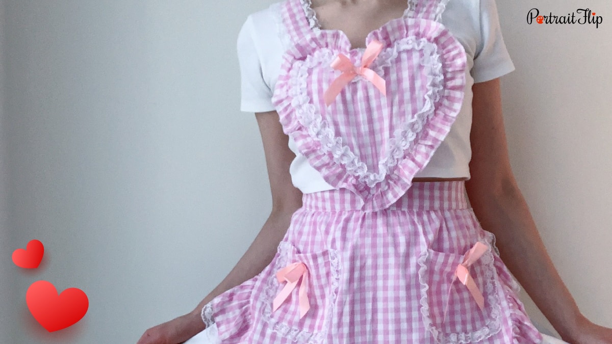 a lady showing off her pink colored heart Apron