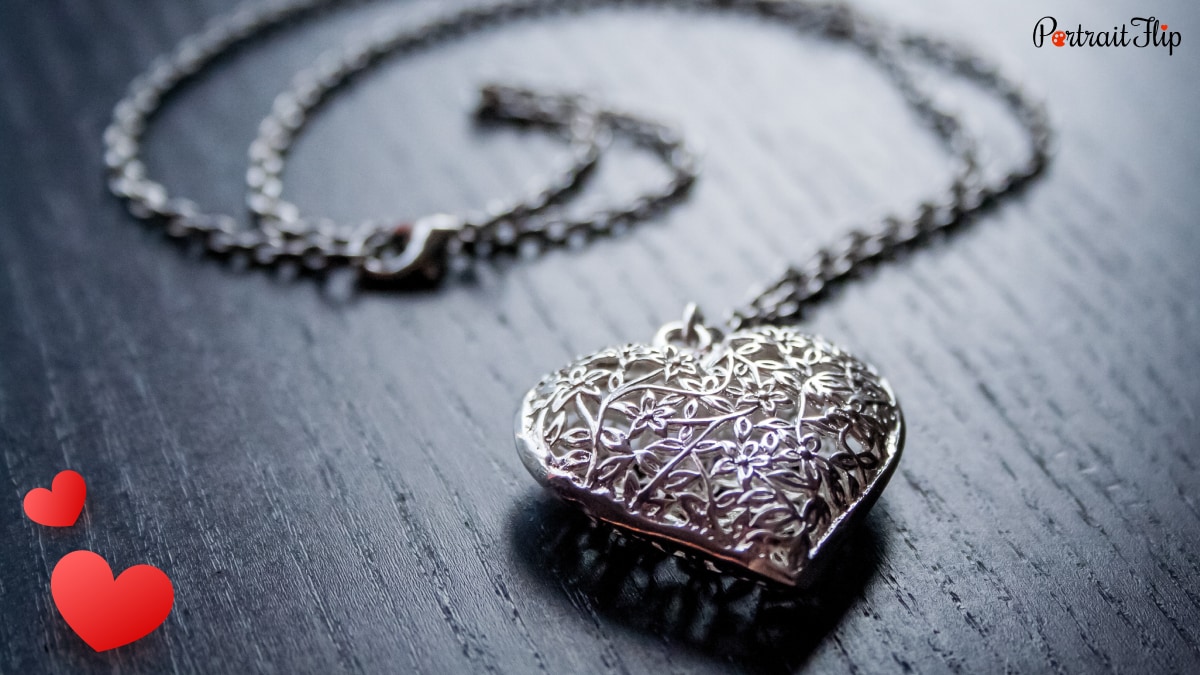 a beautiful silver necklace with a heart pendant. 
