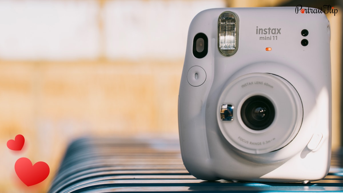 A focused shot of a white Instant camera .
