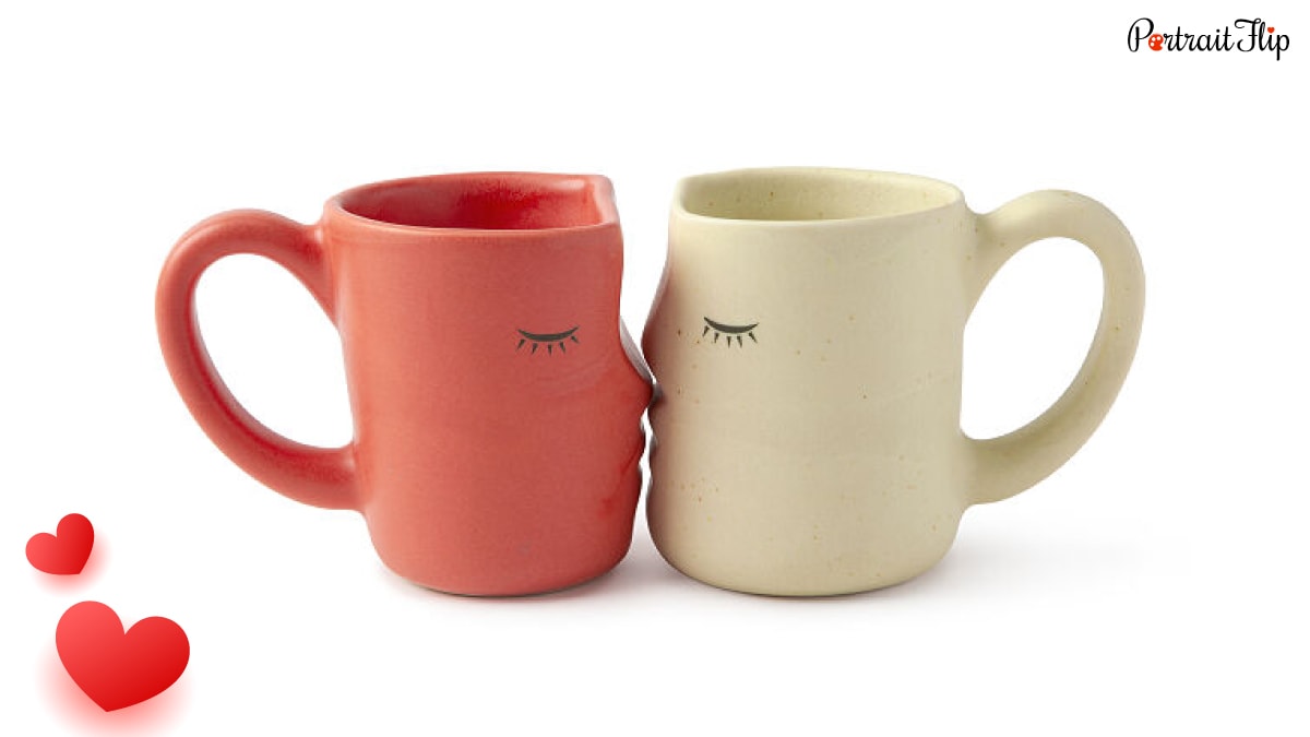 two beautiful kissing mugs! A red mug and white mugs are placed together to look as if they are kissing. 