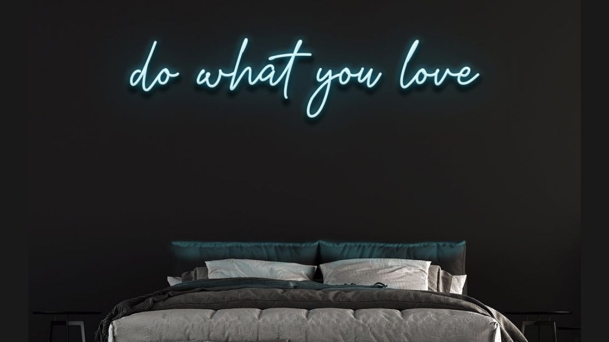 a bedroom wall decorated with neon signs that says do what you love. 