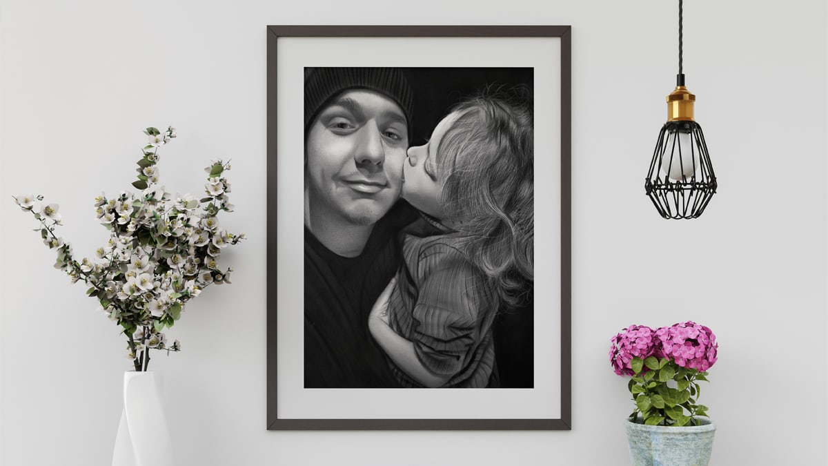 A beautiful interior wall decorated with one of PortraitFlip's customer's kiss portrait of a father-daughter duo where the daughter is seen kissing him with utmost love.