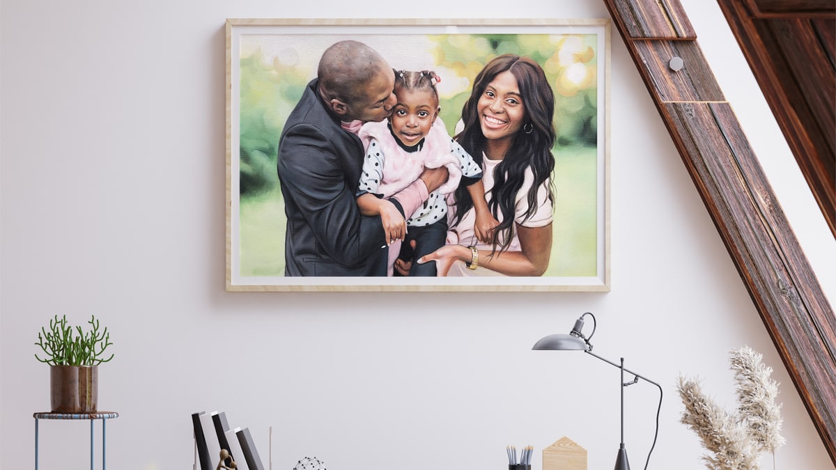 A beautiful interior wall decorated with one of PortraitFlip's customer's kiss portrait of a family of three where the father is kissing his daughter on the forehead.