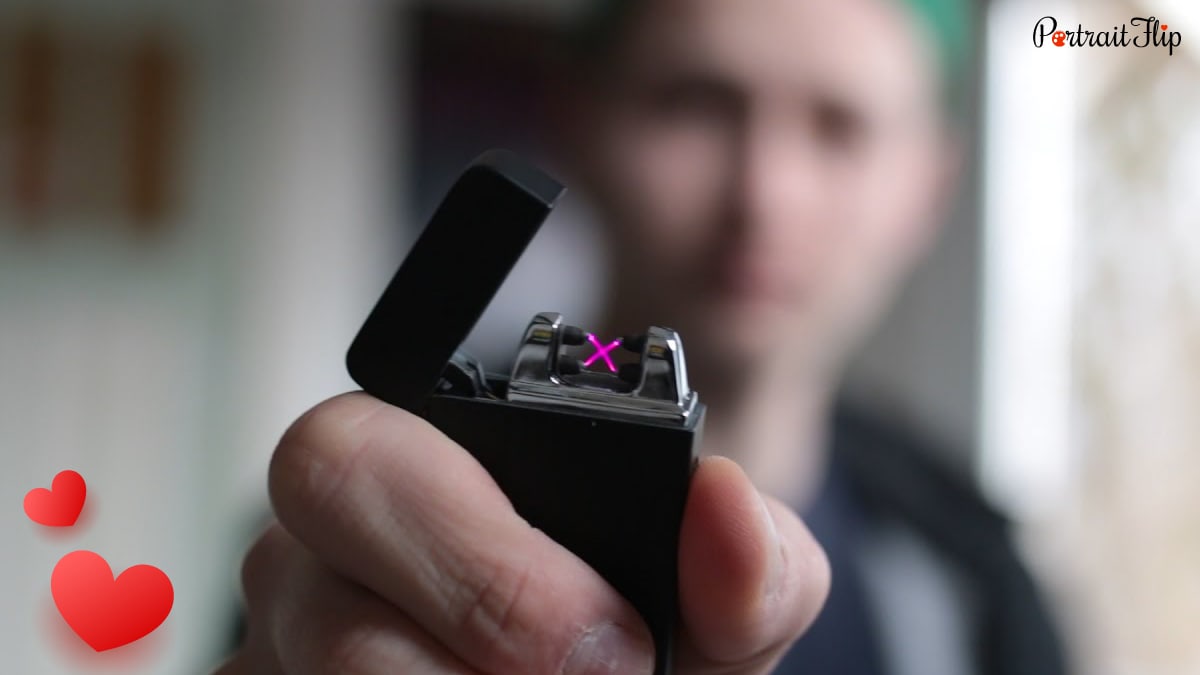 A man holding a Rechargeable Electronic Lighter with purple sparks