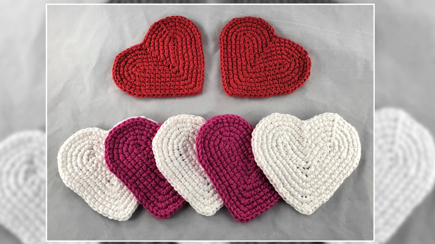 red, pink, and white heart shaped coasters are placed against a grey background
