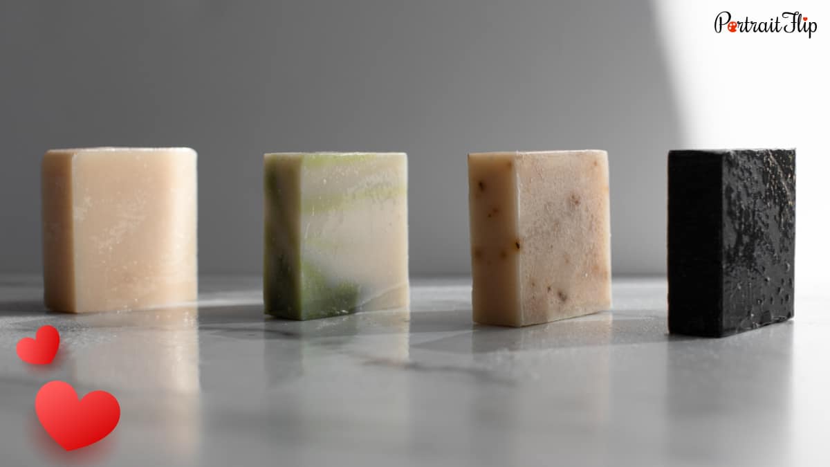 4 blocks of men's scented soap are kept on a table. 