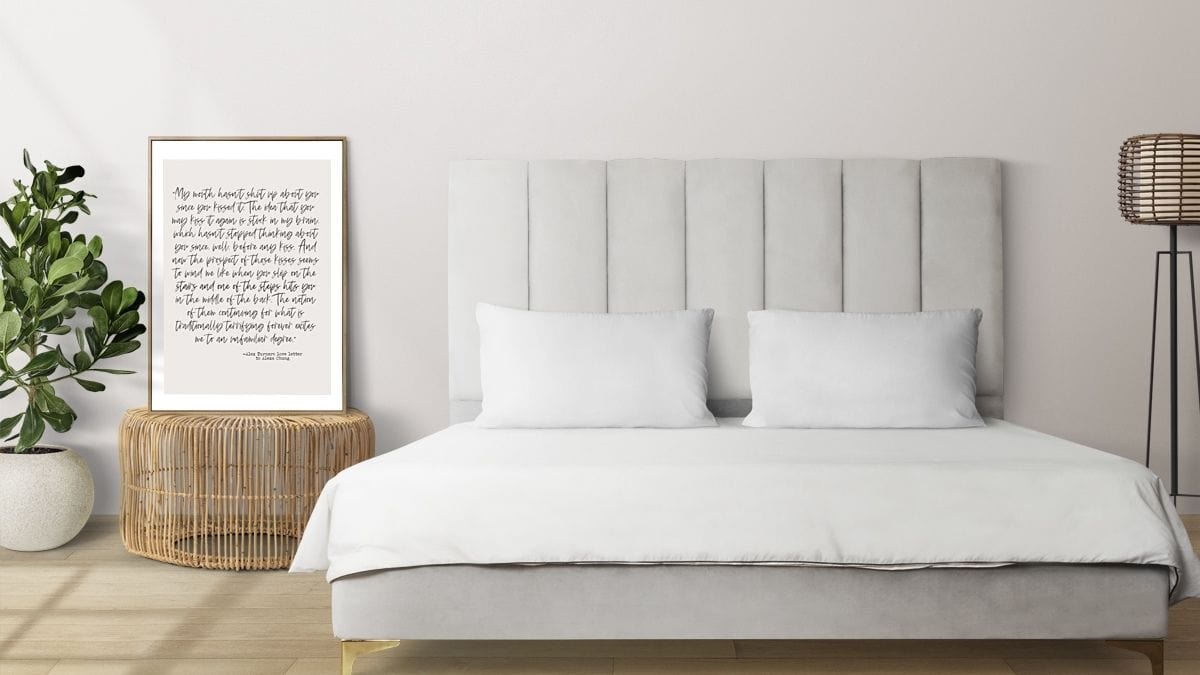 An interior bedroom wall decorated with a leaning framed love letter as a bedroom wall décor idea.