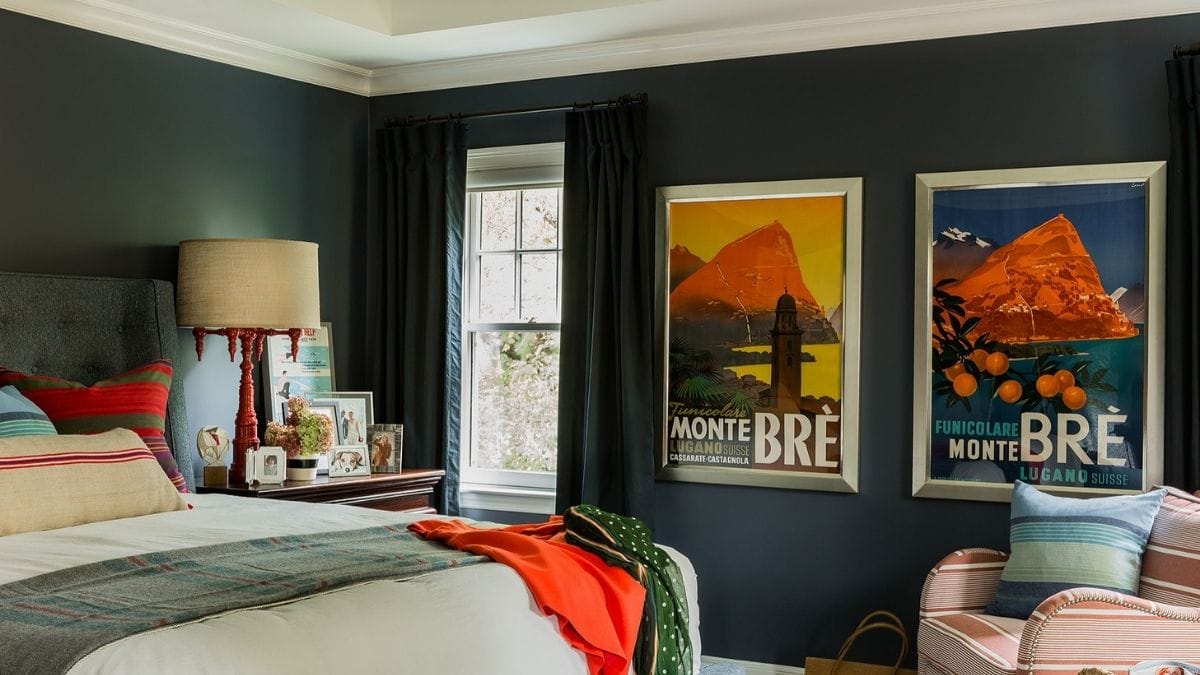 vintage posters displayed on a bedroom wall.