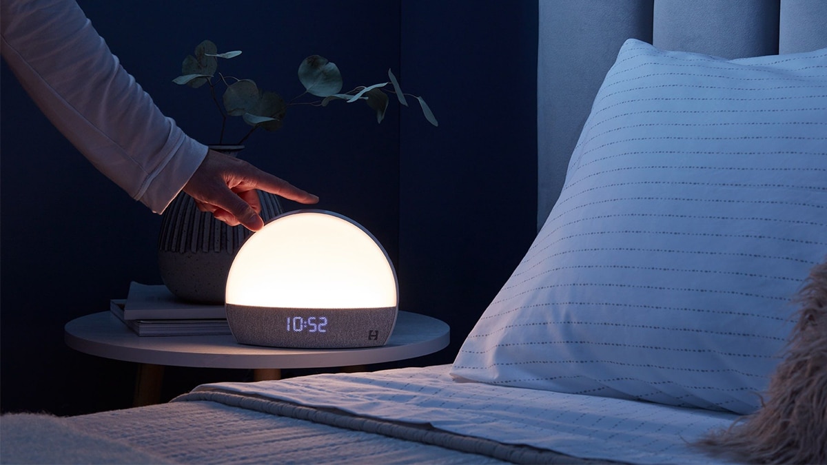 The image shows a person touching the hatch alarm clock, this is one of the other graduation gift ideas for son.