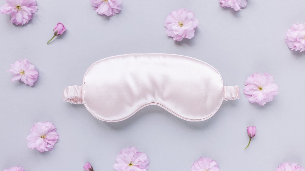 silk sleeping mask with flowers around it for decorative purpose. 