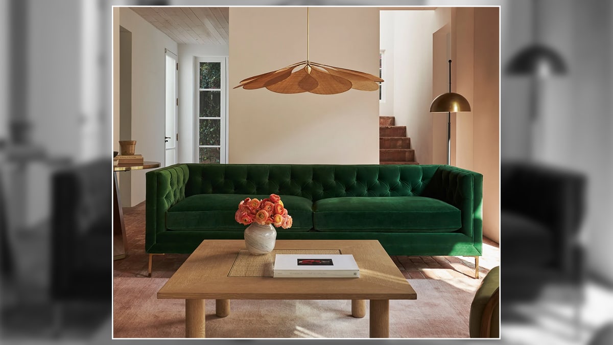 a snapshot of living room with agreen sofa.